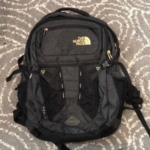 The North Face black and gold backpack women’s
